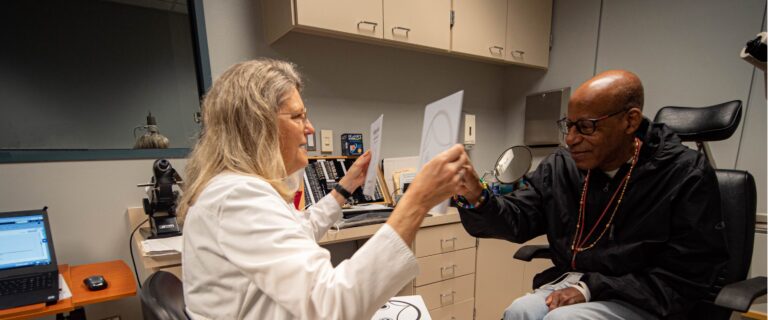 Dr. Eldred doing an eye exam with a client.
