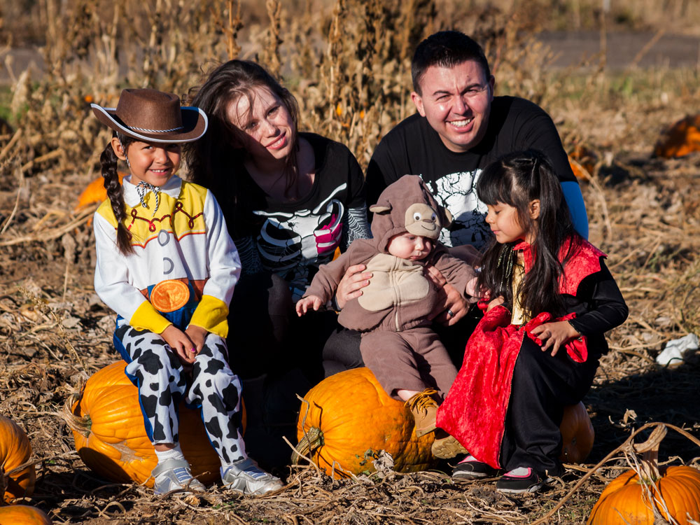 Photo of family in Halloween costumes at Pumpkin Patch Party