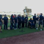 The Lighthouse Choir standing on the field at the Space Cowboys Baseball Game.