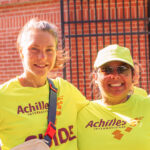 A client and volunteer wearing the Achilles International shirt.