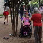 A girl and her mom listening to the Easter eggs beep.