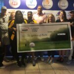 A group photo with NWP staff and Lighthouse of Houston staff posing behind the large check.