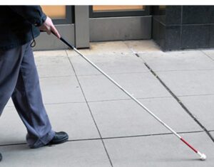 Person walking with white cane