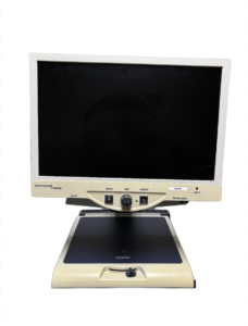 A close-up view of a beige and black electronic device with a screen and controls labeled "Enhanced Vision", "MODE", "SIZE", "POWER", "LIGHT", "BRIGHTNESS", and "AUTO".