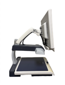 A desktop magnifier with a screen on an adjustable arm over a flat scanning surface.