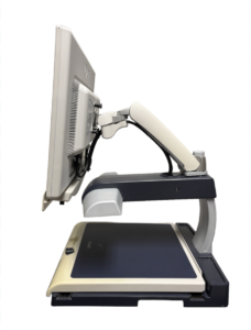 A desktop magnifier with a screen on an adjustable arm over a flat scanning surface.