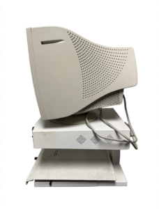 A beige CRT monitor is shown from the side, mounted on a white stand with a keyboard tray.