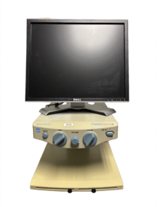A beige SmartView PulseData magnification device with a Dell monitor on top. It features several control knobs labeled MODE, SIZE, PICTURE, FOCUS, and ON-OFF.