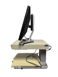 A dual monitor setup on a beige and gray stand with a keyboard tray underneath. The monitors are black with silver stands.
