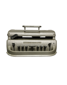 A vintage Perkins Brailler machine with a handle on top and a row of keys below.